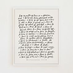 a handwritten poem in black ink on a white paper framed in a white frame