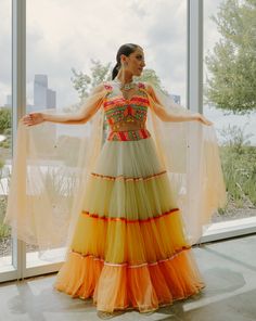 A tulle lehenga with all the shades of sunset paired with a multicolored embroidered blouse.From Liz Paul’s Monet’s Garden collection. DELIVERY TIMEPlease allow 8-12 weeks for your outfit to arrive. FABRIC DETAILSTulle.Professional Cleaning only. Luxury Multicolor Traditional Wear For Party, Cheap Multicolor Traditional Wear For Party, Cheap Multicolor Traditional Wear For Festive Season, Affordable Multicolor Traditional Party Wear, Multicolour Lehenga For Haldi, Multi Colour Lehenga For Haldi, Unique Haldi Outfits, Haldi Poses, Tulle Lehenga