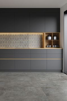 an empty kitchen with grey cabinets and yellow lights on the countertop, along with gray tile flooring