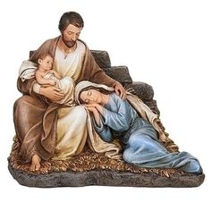 a statue of jesus holding the baby jesus in his arms and kneeling down next to him