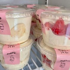 several plastic containers filled with yogurt and fruit