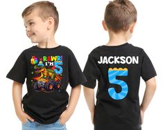 two young boys wearing black shirts with cartoon characters on the front and number 5 on the back