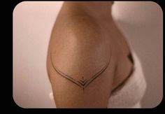 a woman's arm with a tattoo on it that is shaped like an arrow