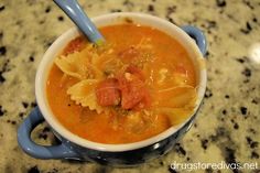 a blue and white bowl filled with pasta soup