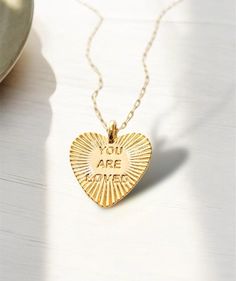 Carry love and positivity wherever you go with our You Are Loved Necklace!  This delicate piece serves as a daily reminder, radiating warmth and confidence with every wear. Inspirational Gold Necklaces For Valentine's Day, Inspirational Gold Necklace For Valentine's Day, Inspirational Gold Heart Jewelry, Inspirational Heart-shaped Gold Jewelry, Trendy Valentine's Day Charm Necklace, Cute Gold Necklace, Gf Gifts, Necklace Minimalist Jewelry, Citation Positive