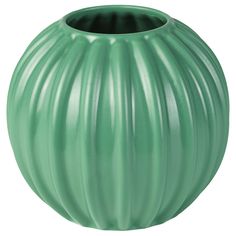 a large green vase sitting on top of a white table