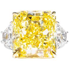 This important and rare fancy yellow radiant diamond is offered by Shreve, Crump & Low. It is custom set in a handcrafted Shreve, Crump & Low Platinum and 18 karat yellow gold 3 stone ring consisting of 1 radiant cut yellow diamond weighing 20.24 carats with color and clarity of Fancy Intense Yellow VVS2 accompanied by GIA report No. 1172184520 accenting by two trapeziod shape diamonds with a total weight of 1.44 carats and a respective color and clarity of D VS1 setting is a ring size 6.5 stamped on the inside shank with our hallmark "SCL PT 18K". Shreve, Crump & Low is one of America's oldest and most prestigious jewelry and fine gift establishments founded in 1796. Shreve, Crump & Low currently has storefronts in Boston, MA and Greenwich, CT. For over 200 years Shreve, Crump & Low has m Canary Diamond Ring, Canary Yellow Diamonds, Radiant Diamond Rings, Radiant Cut Diamond Ring, Canary Diamond, Cushion Diamond Ring, Yellow Diamonds Engagement, Cushion Cut Diamond Ring, Yellow Diamond Engagement Ring