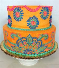 a three layer cake decorated with bright colors