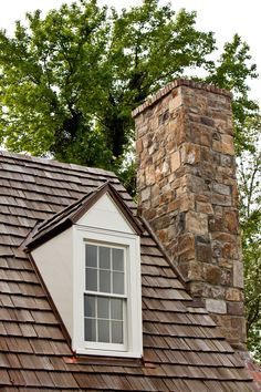 a brick chimney on the roof of a house