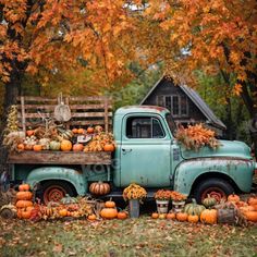 an old truck with pumpkins and gourds in the back