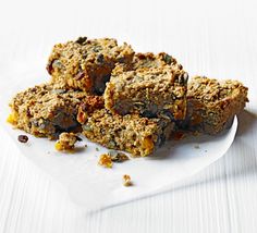 a white plate topped with granola bars on top of a table