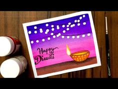 a card with the words happy diwali on it next to some paint bottles