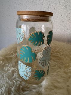 a glass jar sitting on top of a white furnishing covered floor next to a wall