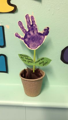 a hand print on a flower in a pot