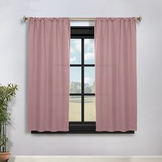 a window with pink curtains and a potted plant