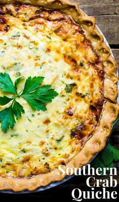 the southern crab quiche is topped with parsley and served on a wooden table