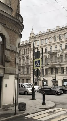 an intersection with cars and buildings in the background