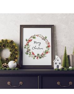 a christmas wreath is on top of a mantle