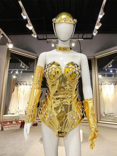 a mannequin dressed in gold is displayed