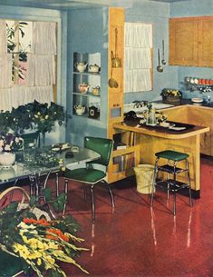 an old fashioned kitchen with blue walls and wooden cabinets is shown in this vintage photo