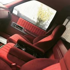 the interior of a car with red seats