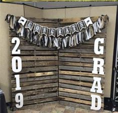 a sign made out of pallet wood that says graduation