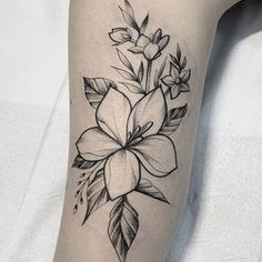 a black and white flower tattoo on the leg