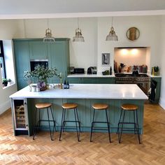 a kitchen island with three stools next to it