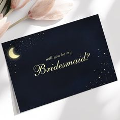 a card with the words will you be my bridesmaid? on it next to some tulips