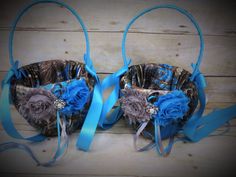 two baskets decorated with blue ribbons and flowers