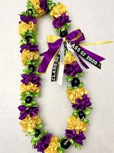 a purple and yellow wreath with flowers on it