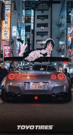 the back end of a car with an advertisement on it's hood in tokyo