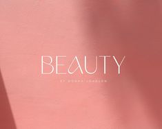 a pink wall with the word beauty written on it