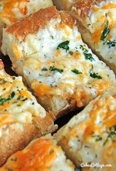 several pieces of bread with cheese and spinach on them