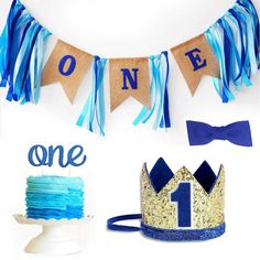 blue and gold first birthday party supplies including cake, cupcakes, streamers and decorations