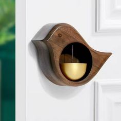 a bird shaped object mounted to the side of a door with a light in it