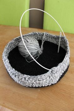 a basket with yarn in it sitting on a table