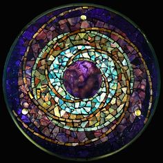 a circular stained glass window in the shape of a circle with an animal on it