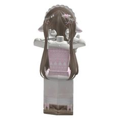 a cardboard doll with long brown hair wearing a pink and white dress on it's head