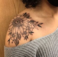 a woman with a sunflower tattoo on her shoulder