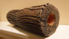 a piece of rock sitting on top of a white shelf