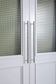 a white double door with glass panels on the front and side doors are open to reveal an interesting pattern