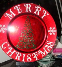 a red merry christmas plate sitting on top of a table