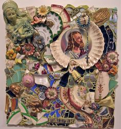 a piece of art made out of plates and other items on a white surface with an image of jesus in the center