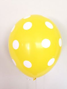 a yellow balloon with white polka dots on it