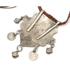 Silver Afghan Dowry Amulet Amulet features a beautiful chased design of a Peahen capturing a Fish, with Emperor Edward VII coin pendants Measures approx. 3 3/4" x 2 3/4", cord length is 30" 80% silver by weight. Origin is Afghanistan, early 20th C. Traditional Adjustable Medallion Jewelry, Amulet Style Medallion Necklace With Coin Pendant, Engraved Amulet Medallion Necklace, Amulet Style Coin Pendant Necklace, Traditional Adjustable Cord Festival Jewelry, Handmade Amulet Coin Necklace, Engraved Coin-shaped Amulet Jewelry, Traditional Adjustable Coin Jewelry, Traditional Medallion Necklace For Collectors