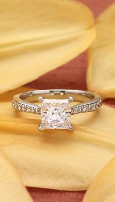 a princess cut engagement ring with pave diamonds