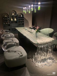 a table with chairs and vases on it in a room filled with glass bottles