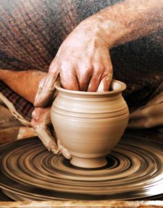 a person is making a pot on a potter's wheel