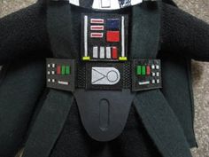 a star wars darth vader costume made out of black material with green and red buttons